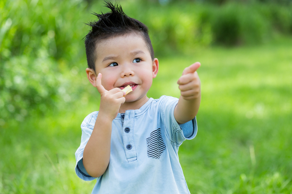 Kid Eating Snack with Thumb up Gesture